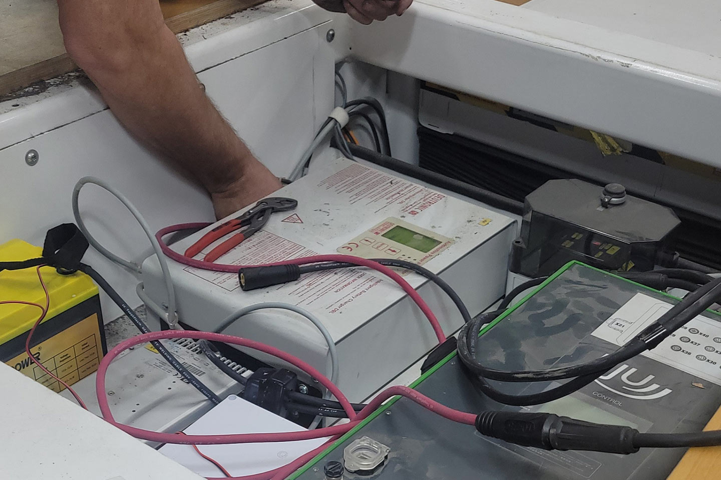 technician using testing equipment to diagnose an issue with a machine component