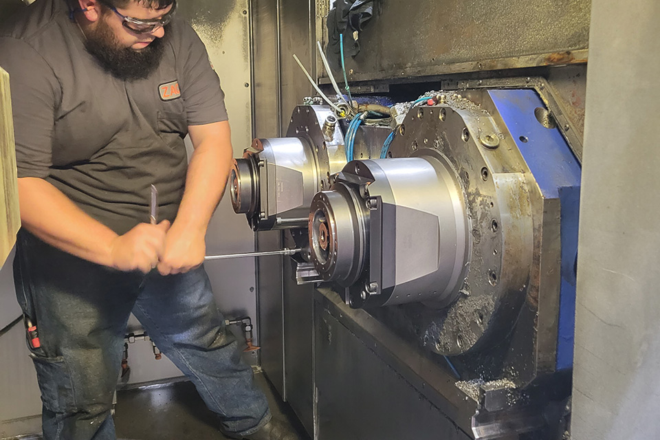 technician working on a machine component in an industrial facility