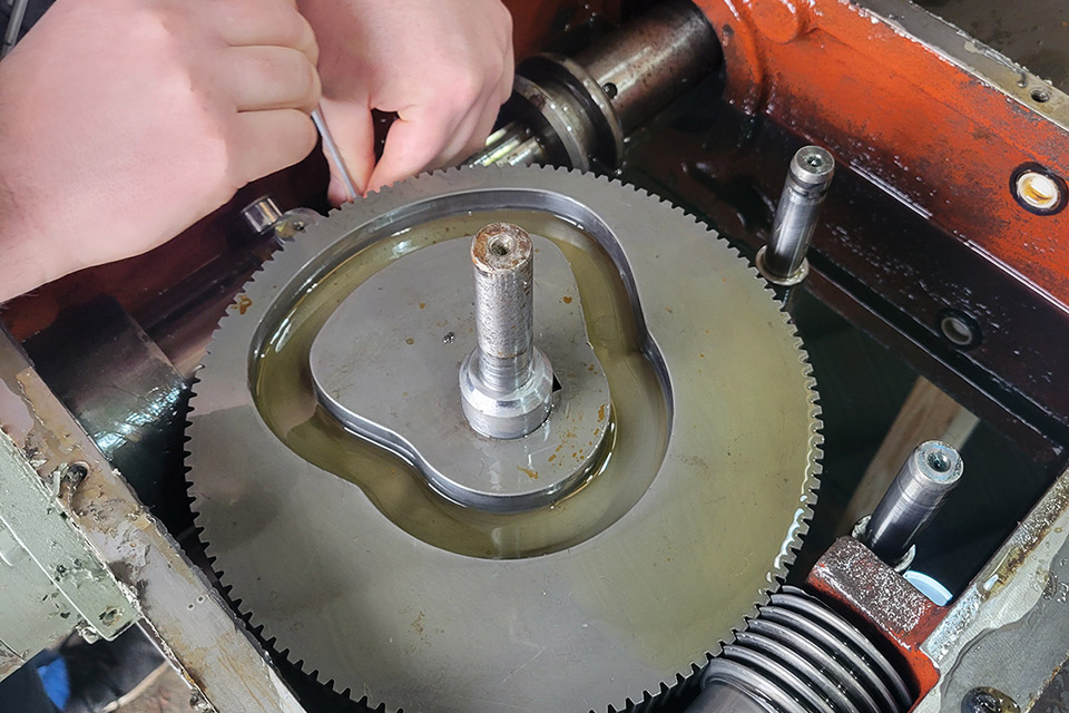 technician working on machine components in the shop