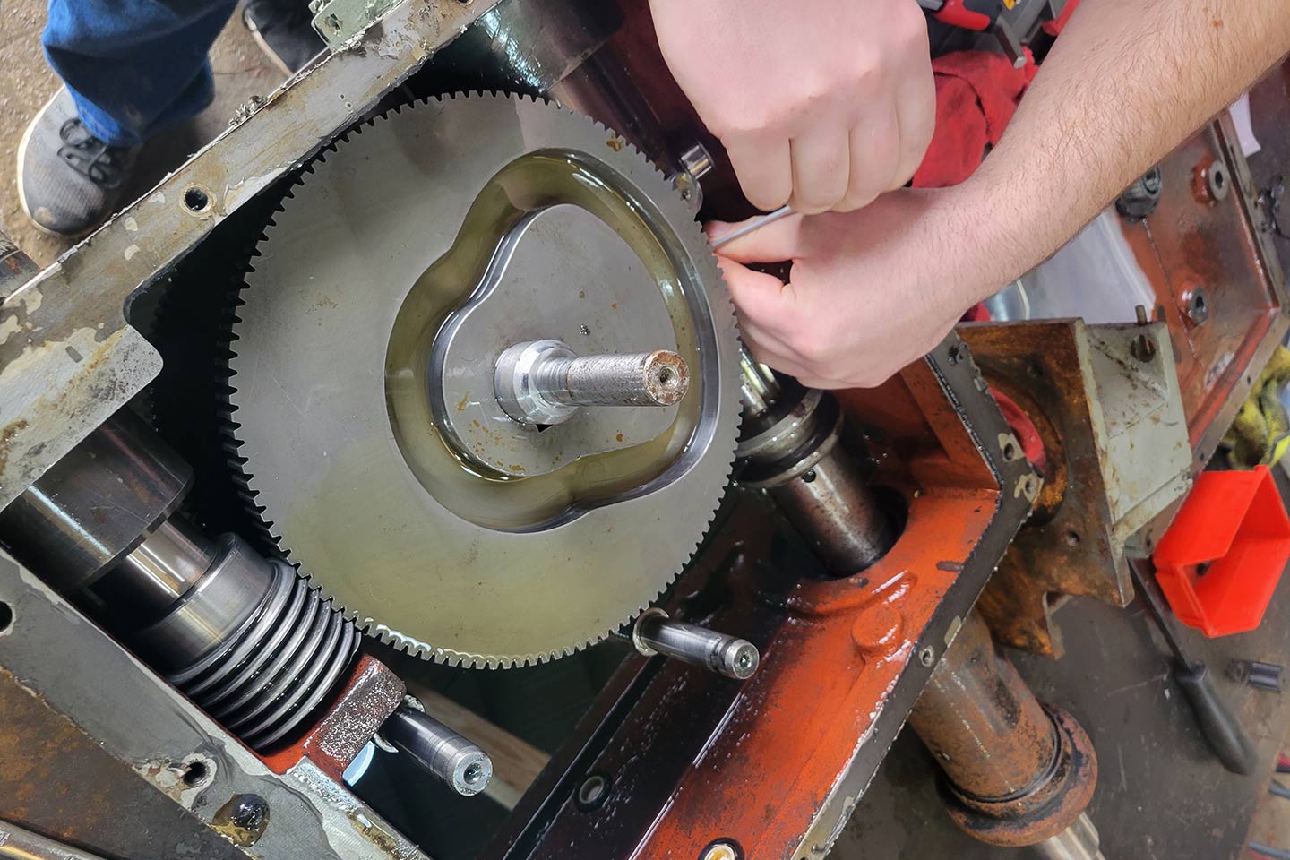 technician fixing a machine component in our shop